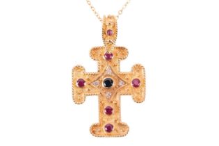 A gem-set cross pendant on chain, containing circular-cut rubies and sapphires along with diamond