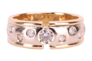 A diamond set band ring. The principle brilliant-cut diamond in a ‘sunk’ setting , the remaining