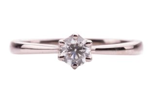 A diamond solitaire ring in 18ct white gold, claw-set with a round brilliant-cut diamond of 0.