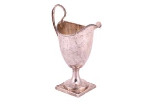 A George III Newcastle silver helmet cream jug; with beaded borders and scroll handle; foliate