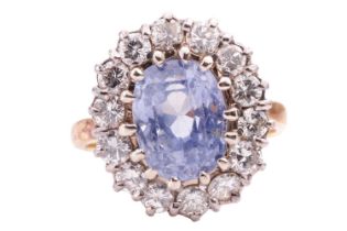 A sapphire and diamond entourage ring, featuring an oval-cut light purplish-blue sapphire,