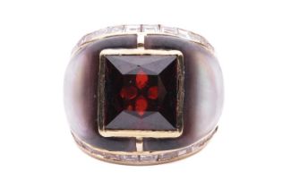 A gem-set cocktail ring, centred with a square scissors-cut garnet in collet, shoulders inlaid