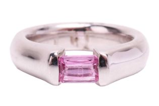 A pink sapphire dress ring, containing an octagonal scissor-cut pink sapphire of 5.5 x 4.0 mm, bar-