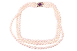 A three-strand cultured pearl necklace, comprising three rows of graduating round pearls with