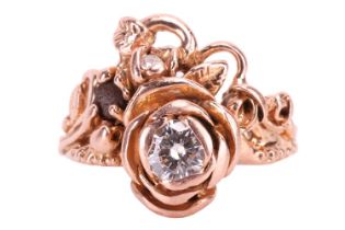 A diamond ring designed as a spray of roses, set with a round brilliant cut diamond with an