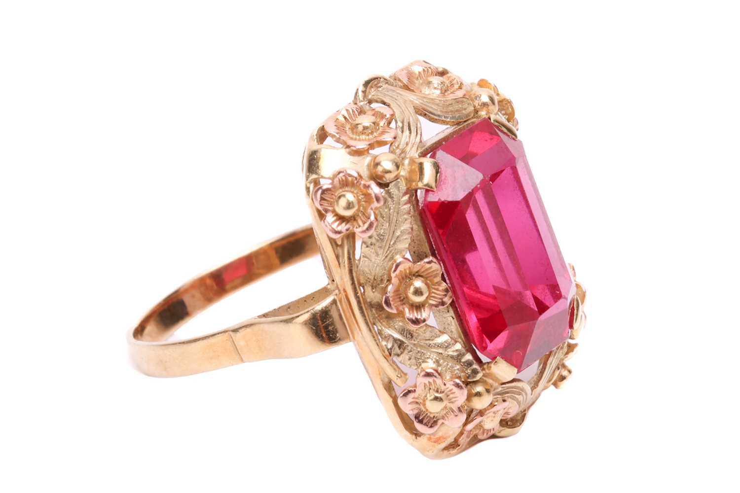 A synthetic ruby dress ring, centred with an octagonal-cut synthetic ruby within an intricately embo - Image 3 of 4