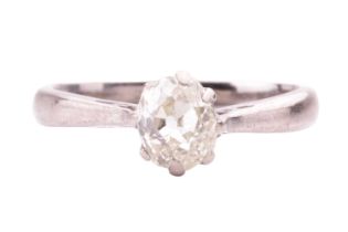An old-cut diamond solitaire ring, coronet-set with an oval old-cut diamond of tinted yellow colour,