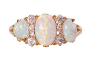 An Edwardian opal and diamond half-hoop ring, comprising three graduated oval-cut precious opals