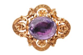 A Victorian amethyst brooch, containing a large oval-cut amethyst of 20.6 x 17.5 mm, within a