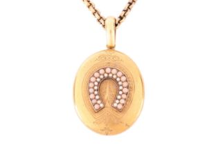 A Victorian pink coral and seed pearl locket, featuring a central horseshoe set with rows of pink