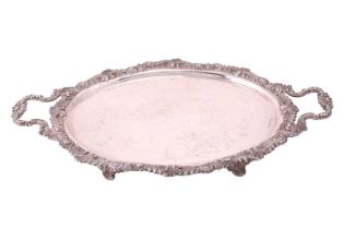 An Edwardian silver two handled tray, oval with cast foliate border and shell mounted foliate side