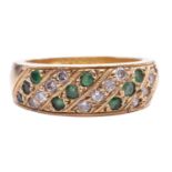 An emerald and diamond-set ring, featuring alternating rows of diamonds and emeralds, grain set in a