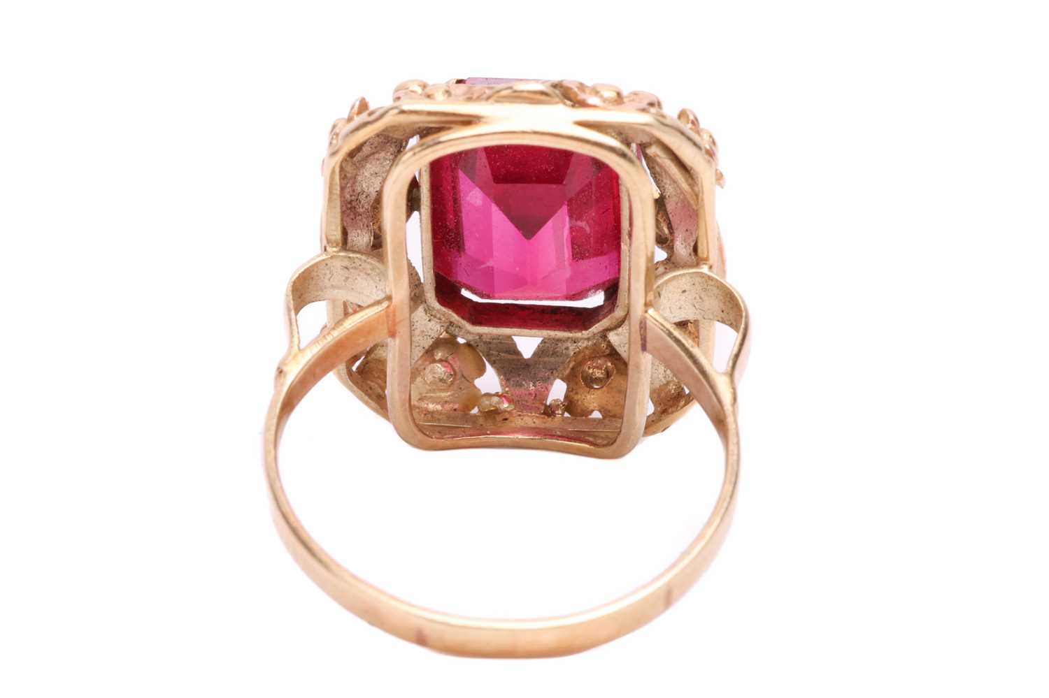 A synthetic ruby dress ring, centred with an octagonal-cut synthetic ruby within an intricately embo - Image 4 of 4