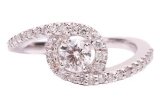 A diamond halo twist ring, the principle round brilliant diamond measuring approximately 4.4mm, with