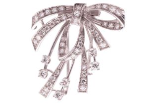 A diamond-set bow dress clip/brooch, the central bow and ribbons claw-set with single-cut