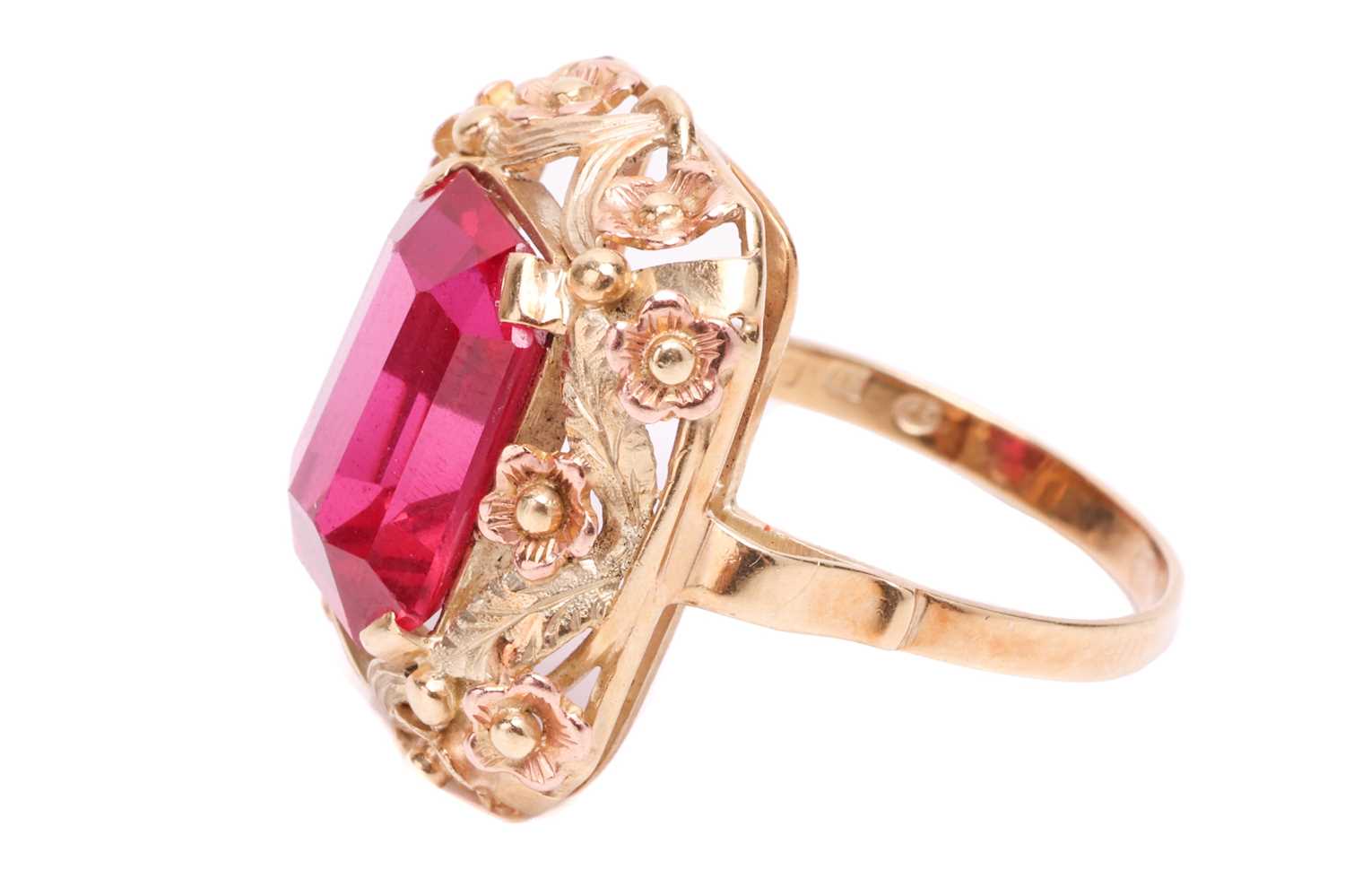 A synthetic ruby dress ring, centred with an octagonal-cut synthetic ruby within an intricately embo - Image 2 of 4