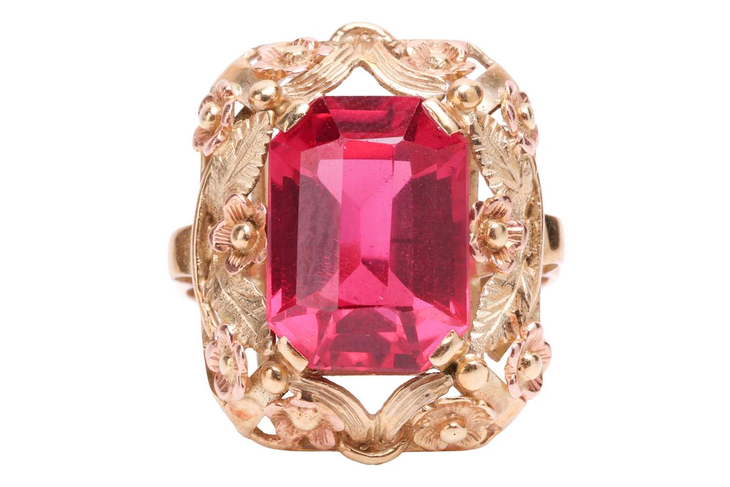 A synthetic ruby dress ring, centred with an octagonal-cut synthetic ruby within an intricately embo