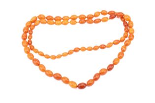 A butterscotch oval amber bead necklace, featuring hand-knotted graduated oval amber beads from 10.2