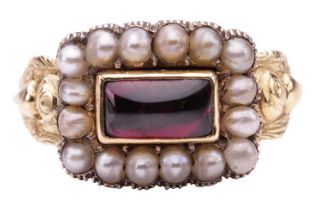 A Victorian mourning ring set with garnet and split pearls, the scalloped rectangular panel