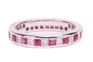A ruby and diamond eternity ring, set with a continuous row of alternating square step cut synthetic