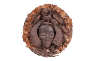 A Chokwe Divination tray or dish, the well with a mask flanked by two horns, feather decoration to