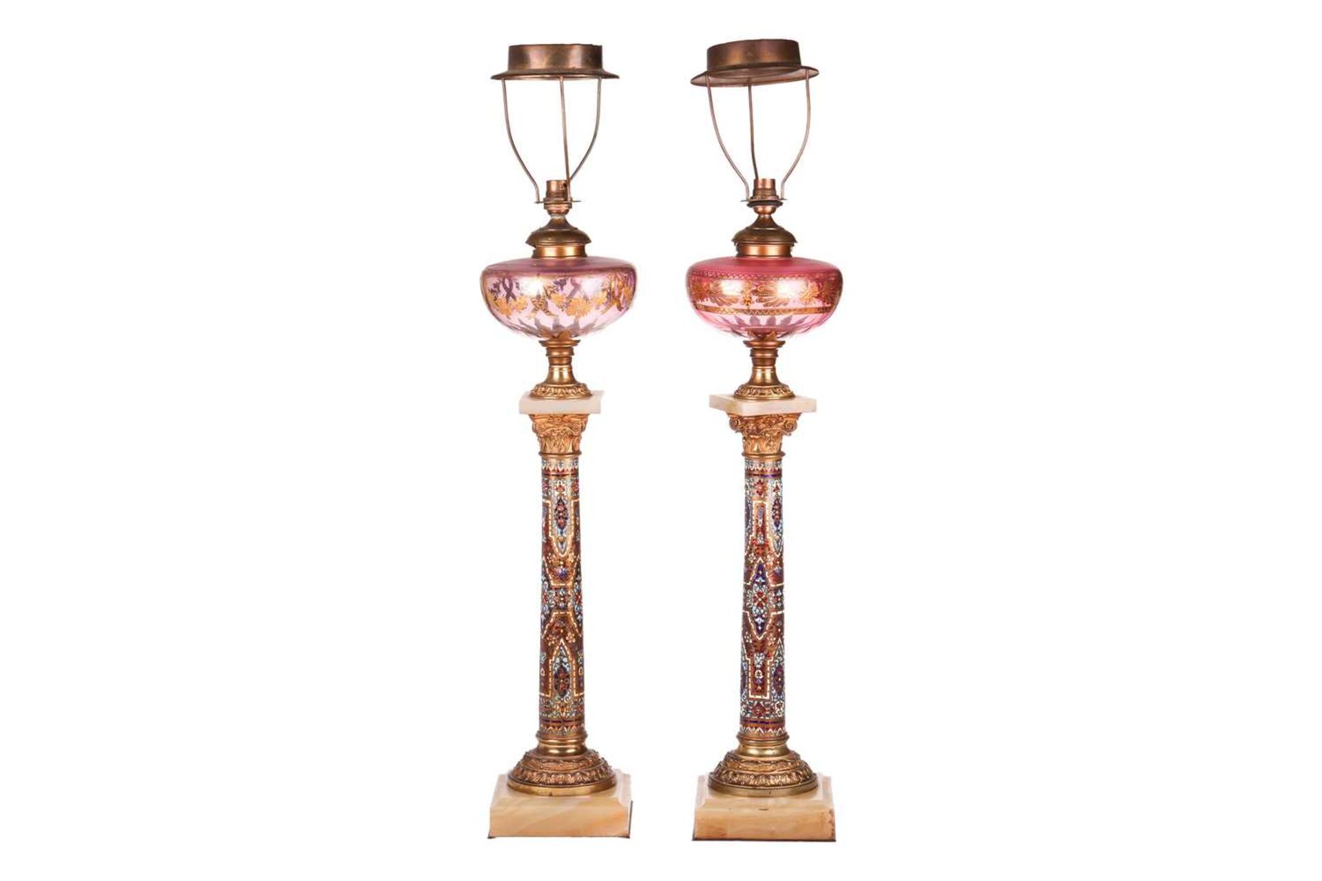 A pair of 19th-century French onyx, gilt metal and champléve enamel oil lamp bases of Corinthian col