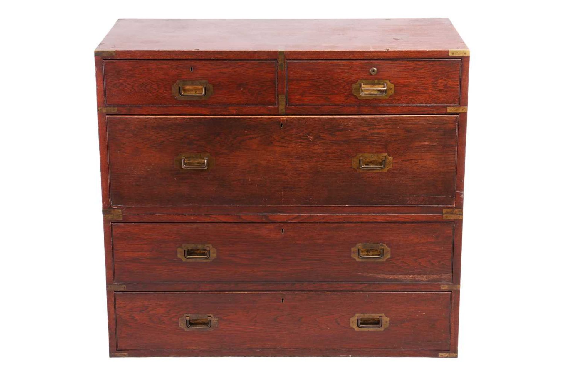 A late Victorian teakwood two-section campaign chest of two short over three long drawers, with sunk