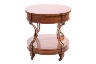 A French Empire-style two-tier drum burr walnut table with concave gilt brass supports over a