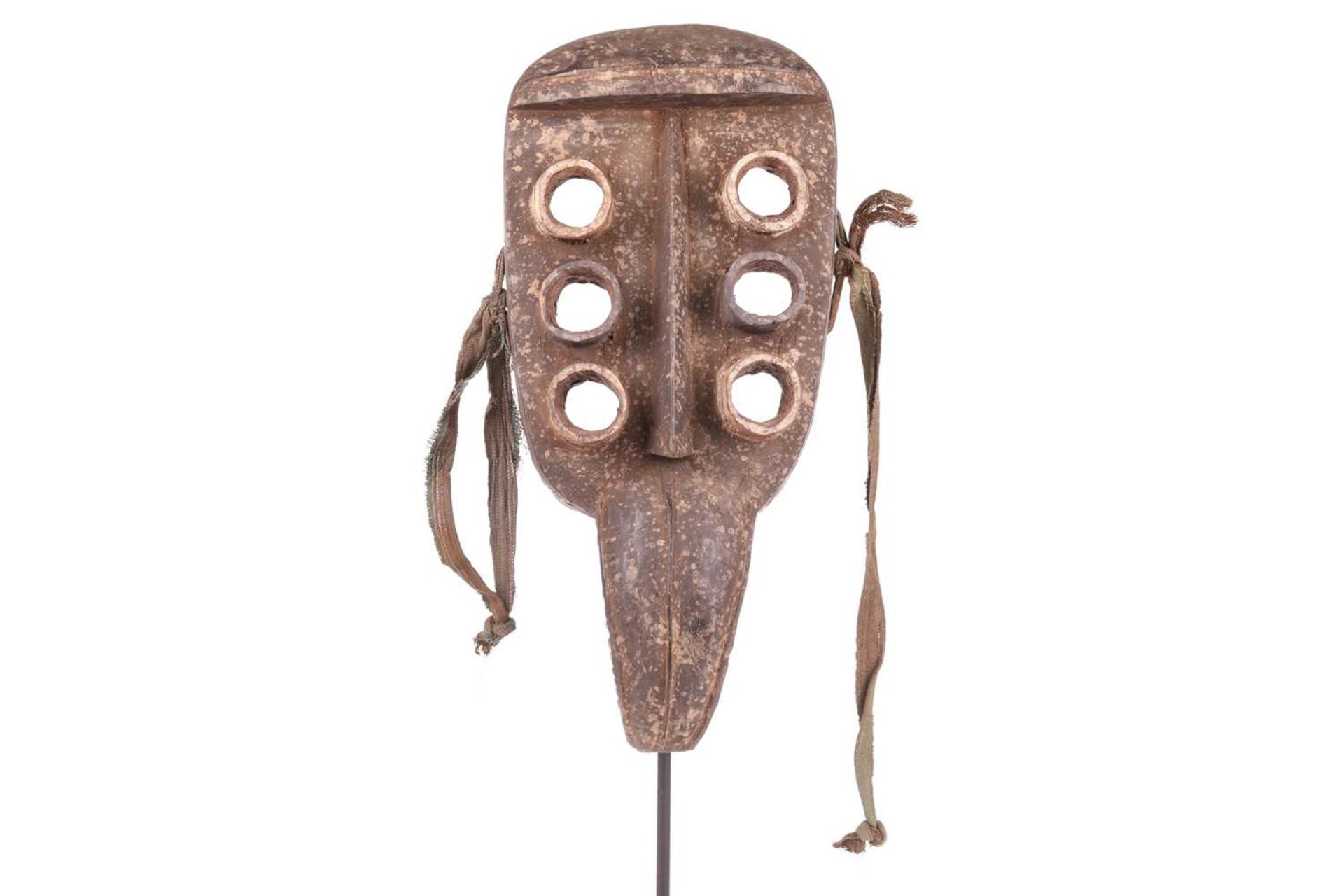 A Grebo ‘Kru’ mask, mid-20th century, 44 cm x 21 cm. NB: Display stand is for illustrative purposes 
