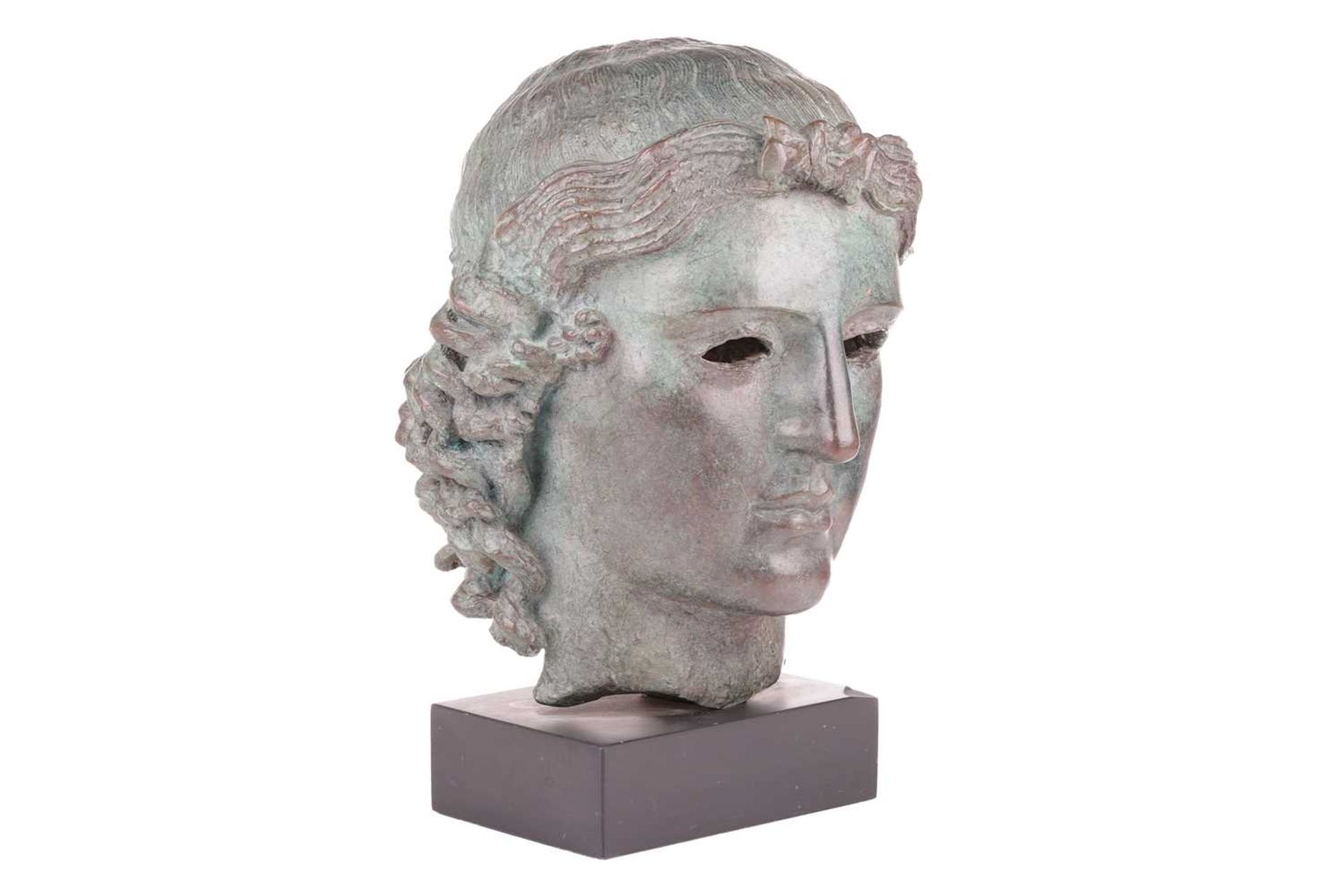 A Grand Tour style patinated bronze, cast after the Chatsworth Apollo Head, raised on a rectangular 