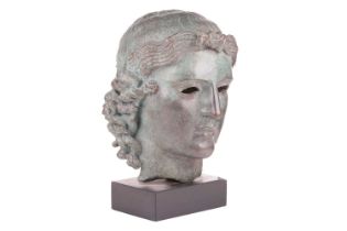 A Grand Tour style patinated bronze, cast after the Chatsworth Apollo Head, raised on a