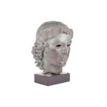 A Grand Tour style patinated bronze, cast after the Chatsworth Apollo Head, raised on a rectangular 