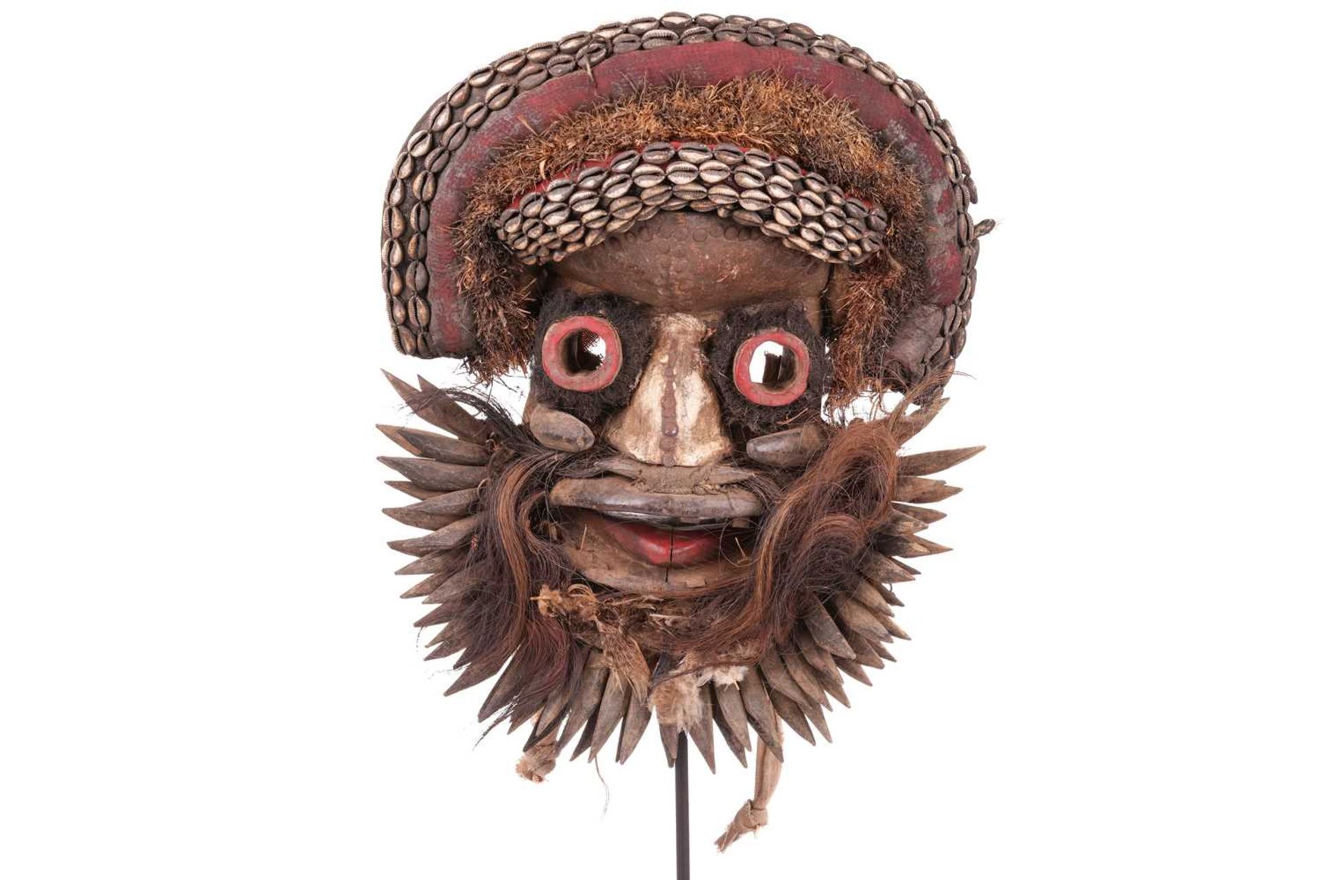 A large Ivory Coast Guerre warrior mask, painted in colours with shell decoration, 20th century, 48 