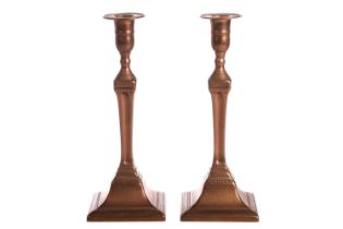 A pair of George III Great Seige of Gibraltar gunmetal candle sticks by T. Warner cast from the