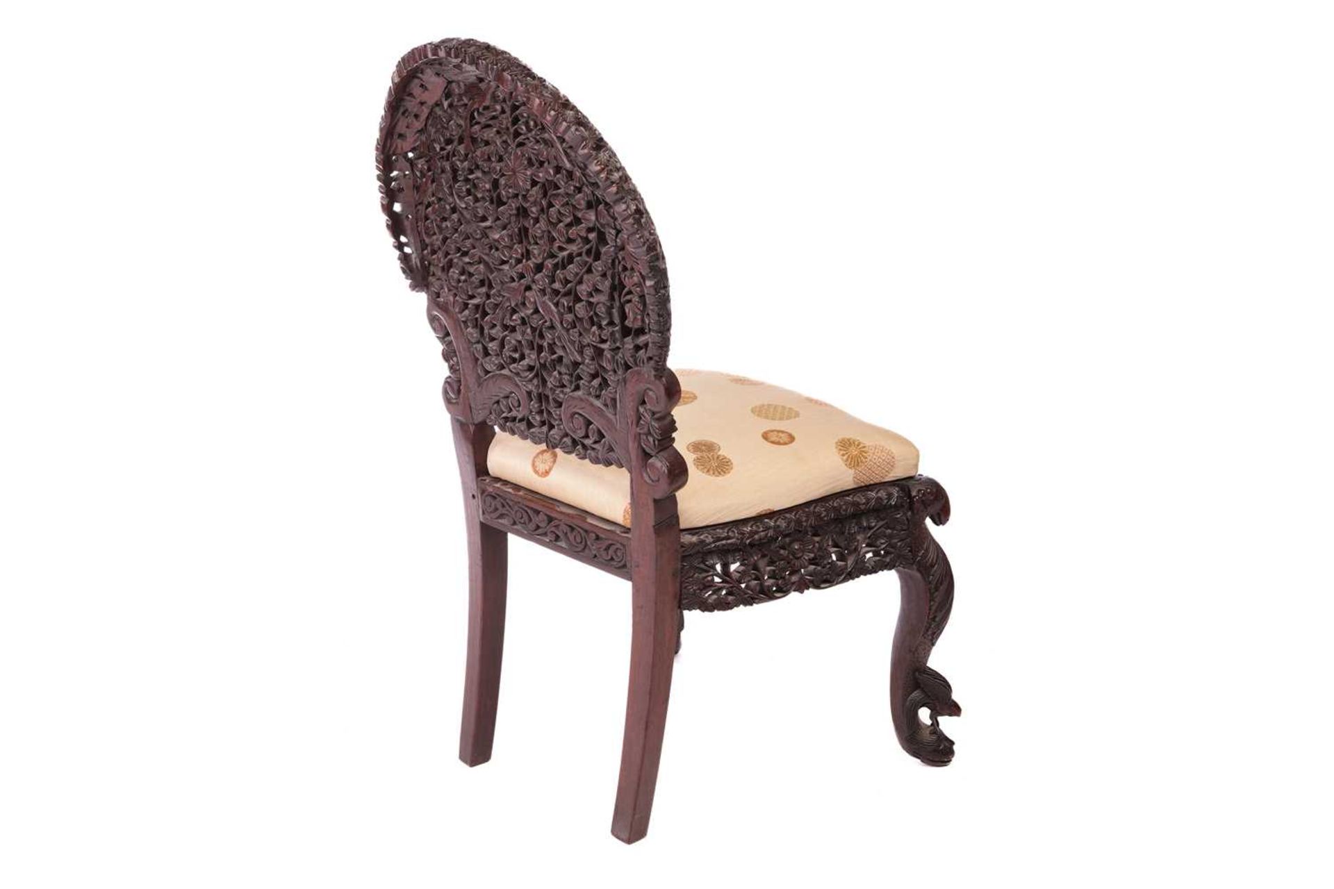 An Indian 'Bombay Carved' padauk slipper chair 19th century, the arched back pierced and carved with - Image 5 of 13