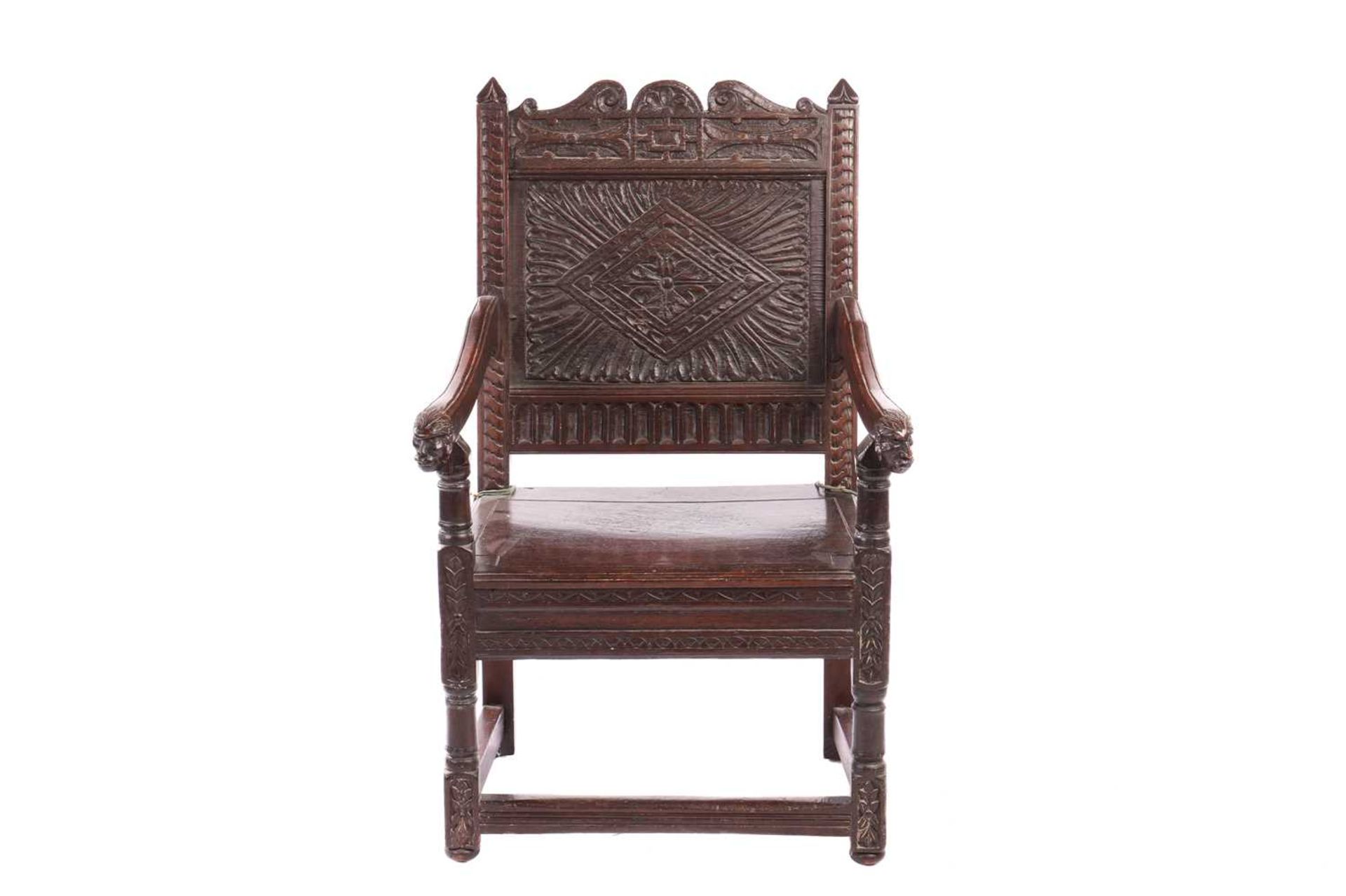 An oak wainscot armchair, 17th century and later, with carved decoration, the arms terminating in ca - Image 2 of 26