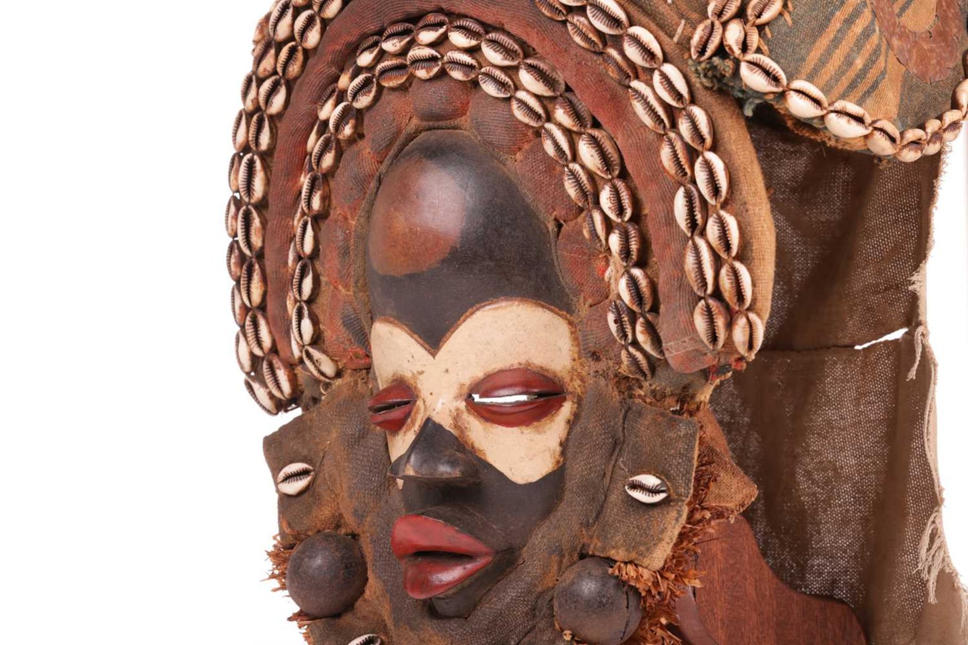 A Dan Gagon Headdress, late 20th century, the mask painted in colours and framed by two rows of shel - Image 6 of 8