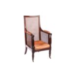 A William IV mahogany bergere library armchair, in the manner of Gillow of Lancaster with square spl