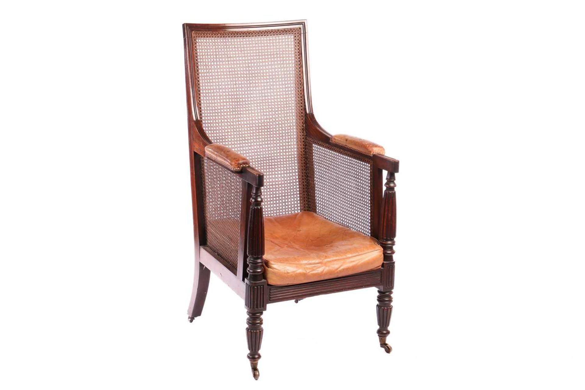 A William IV mahogany bergere library armchair, in the manner of Gillow of Lancaster with square spl