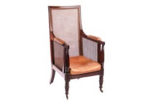 A William IV mahogany bergere library armchair, in the manner of Gillow of Lancaster with square