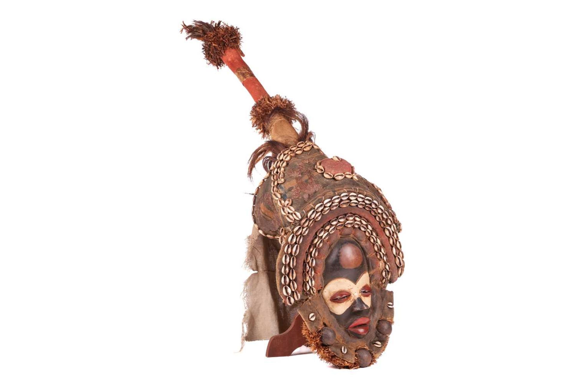 A Dan Gagon Headdress, late 20th century, the mask painted in colours and framed by two rows of shel