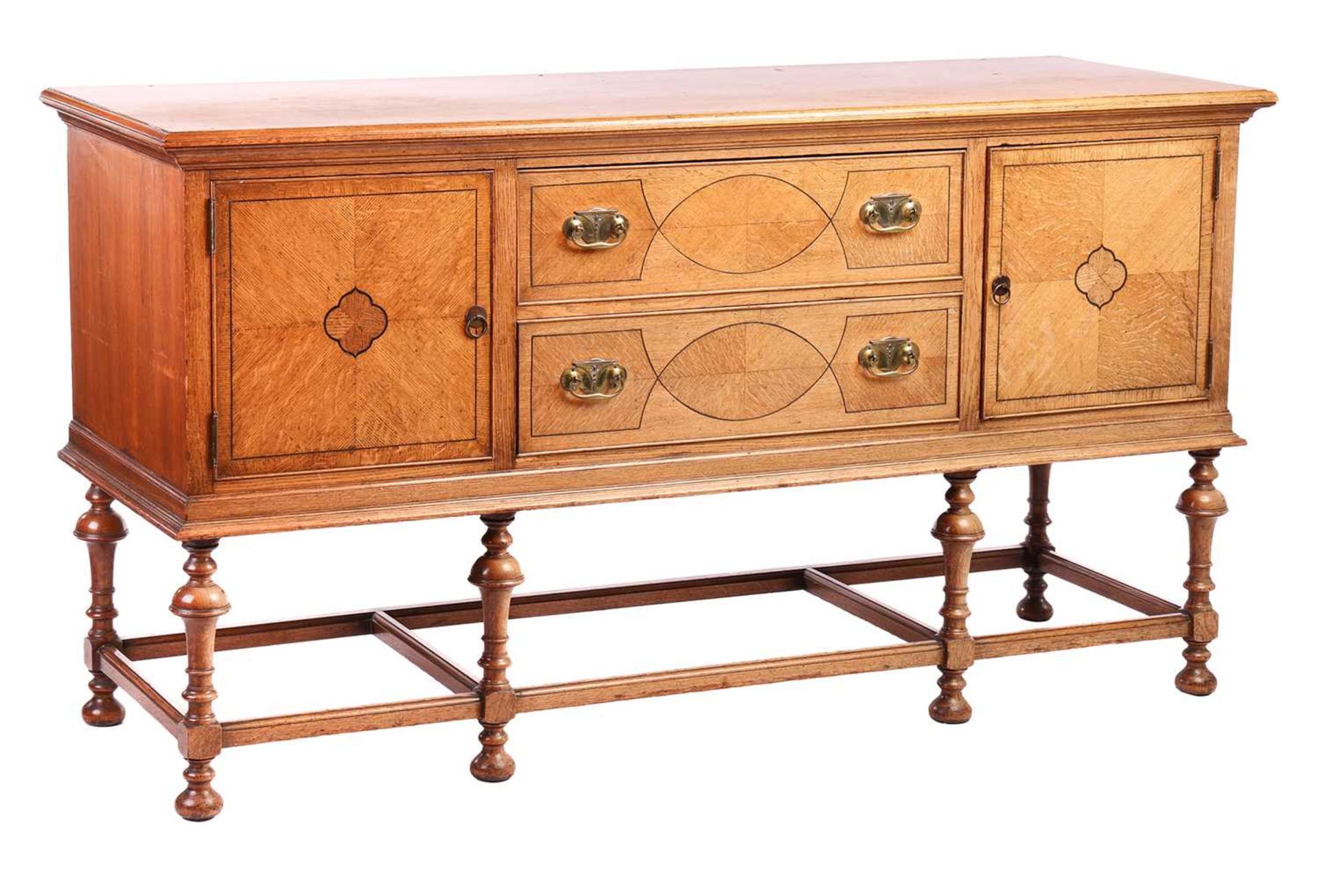 A Morgan and Co. arts and crafts oak sideboard with strung detail to the doors, raised on turned tru