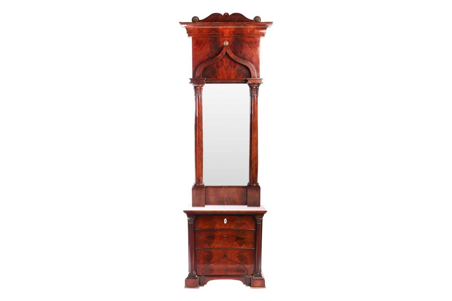 A 19th century Biedermeier or Louis Phillippe flame mahogany pier mirror and commode, the scrolling 