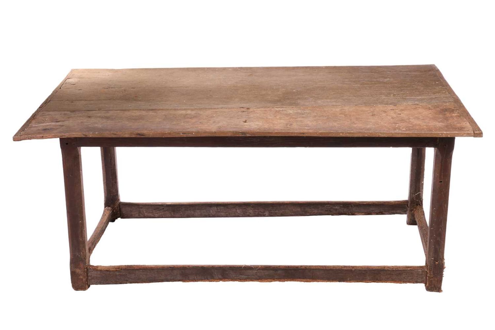 A rustic oak rectangular tavern table, 17th/18th century and later repairs, with a broad planked and