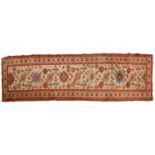 An "Old Country House" ivory ground Malayer runner with large flower heads, within a tiled border, r