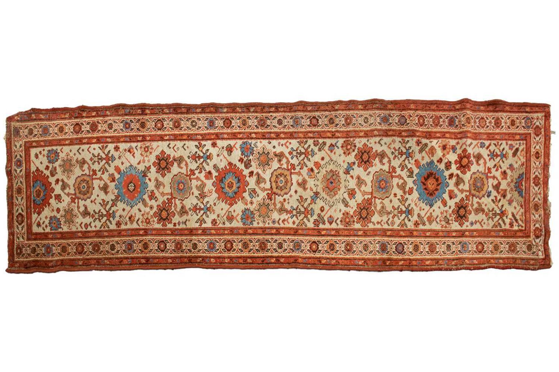 An "Old Country House" ivory ground Malayer runner with large flower heads, within a tiled border, r
