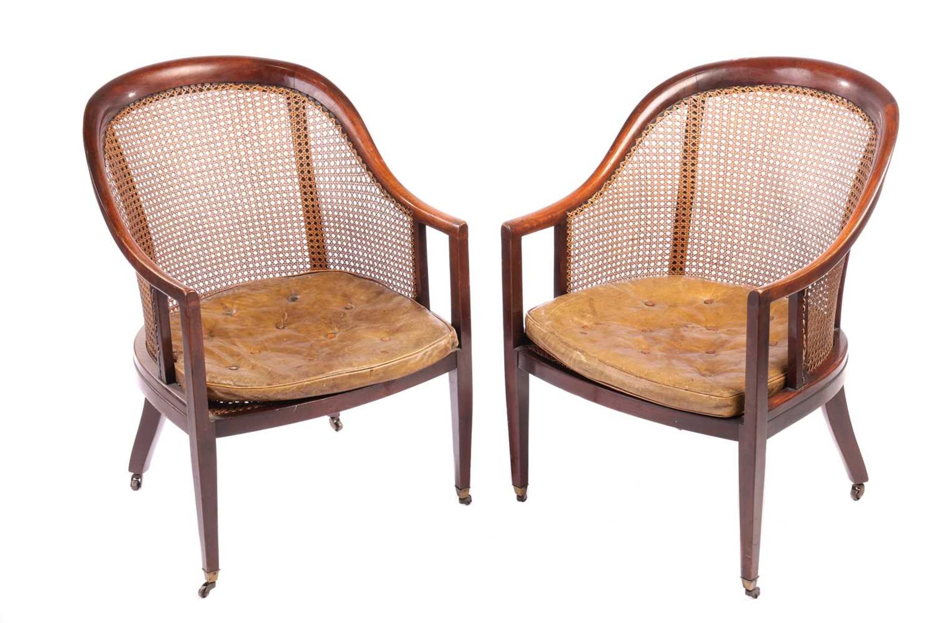 A pair of George IV-style mahogany horseshoe-backed bergerer salon armchairs, 20th-century, each wit