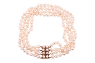 A four-strand pearl choker necklace, the cultured pearls of cream body colour with pink overtones,