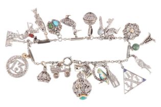 An Art Deco gem-set charm bracelet, two signed Cartier; composed of a series of cable and bar links,