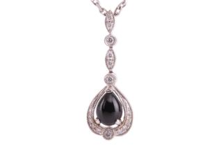 A jet and diamond-set drop pendant, the pear-shaped jet cabochon in a diamond-set mount with